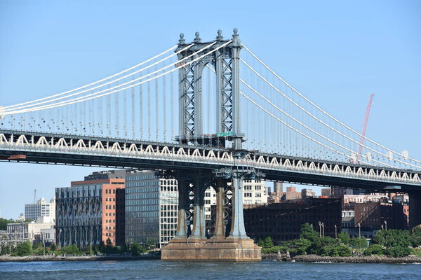 NEW YORK, NY - JUN 30: Manhattan Bridge in New York City, seen on June 30, 2019. is a suspension bridge that crosses the East River in New York City, connecting Lower Manhattan with Downtown Brooklyn.