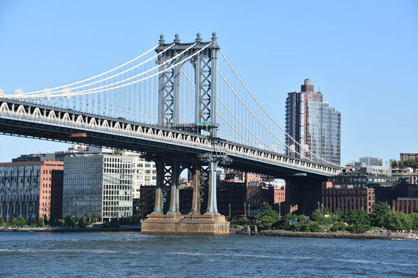NEW YORK, NY - JUN 30: Manhattan Bridge in New York City, seen on June 30, 2019. is a suspension bridge that crosses the East River in New York City, connecting Lower Manhattan with Downtown Brooklyn.