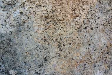 arkaplan, taştan yontulmuş bir bloktan sıçrama ve gri ve kahverengi çizgilerle yaşlandırılmış.