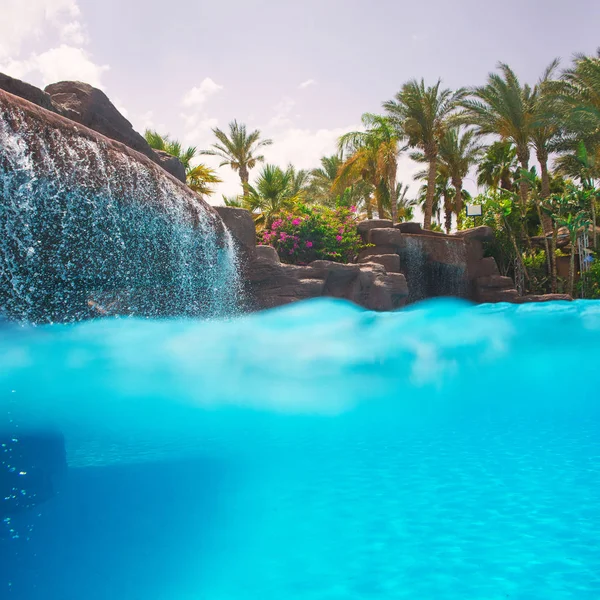 Swimming pool with waterfall — Stock Photo, Image