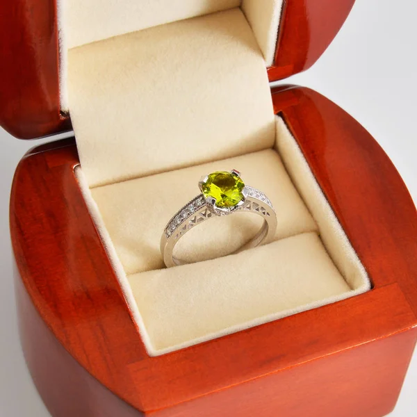 gold ring with a jewel in a wooden box