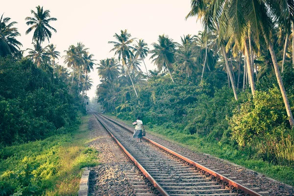 Woman on a railway in the jungle