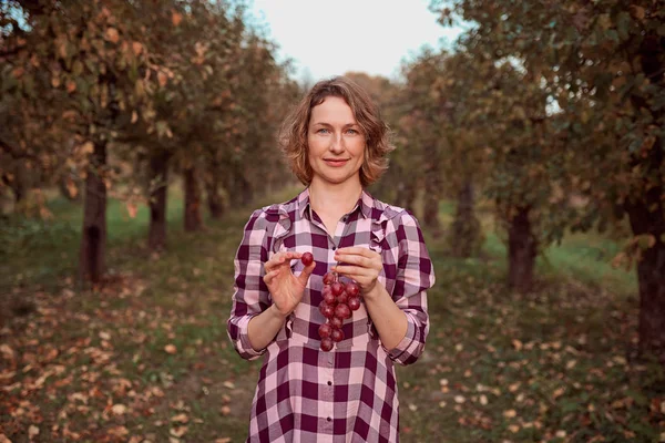 Žena s vínem v zahradě — Stock fotografie