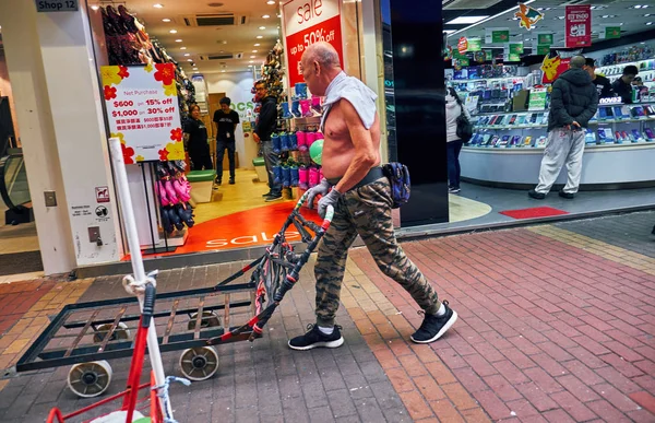 A man with a cart on the sidewalk in Hong Kong — Stock Photo, Image