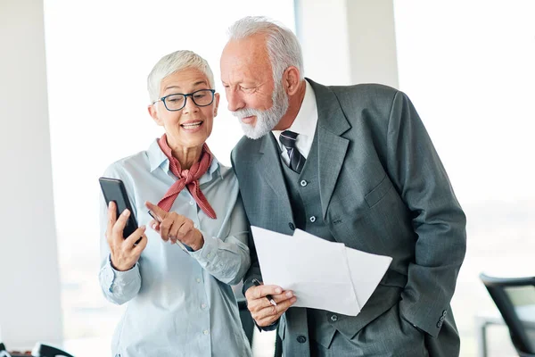 Portrait Two Senior Businesspeople Discussing Mobile Phone Office — Stock Photo, Image