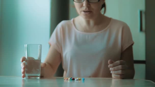 Girl Taking Pills At Home Is Ill Sick Slow Motion Healthcare And Medical Concept Disease Woman Takes A Pill And Drinks A Glof Water Indoors Girl Taking Pills At Home Is Ill Sick Slow Motion Healthcare And Medical Concept Disease Woman Takes A Pill And Drinks A Glof Water Indoors