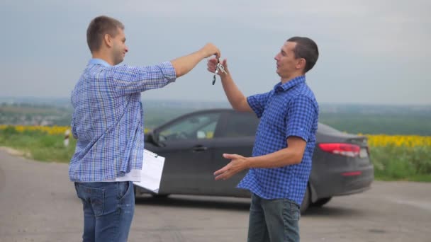 two men make a deal. man seller driver makes car the auto insurance slow motion video. man sale sells used cars. car insurance sale lifestyle of used cars concept. Buying rent a car