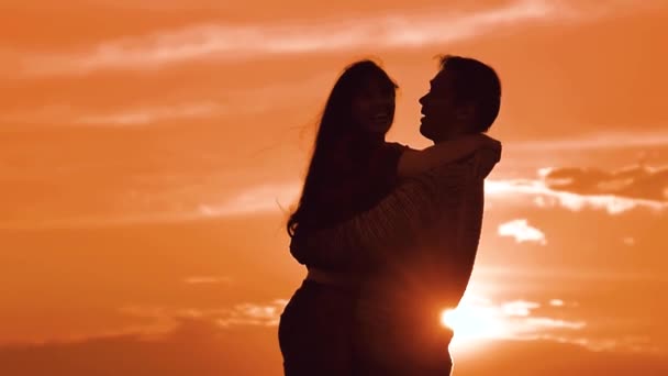 couple in love hugging at sunset sunlight silhouette. family love concept love. Couple man and girl silhouettes of love romantic couples loving couple hugging kissing. Man and woman silhouette in