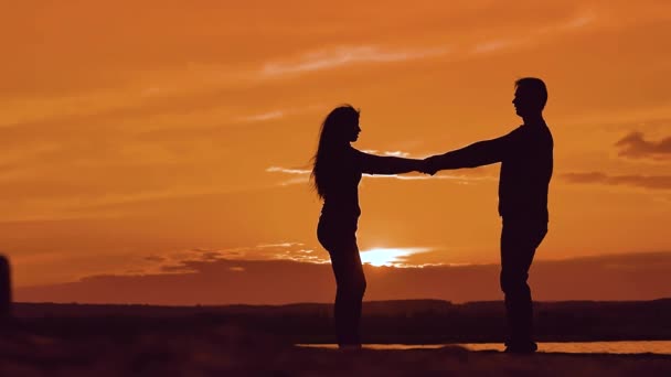 Man and woman spinning hold hands. silhouette man and girl of a happy ...