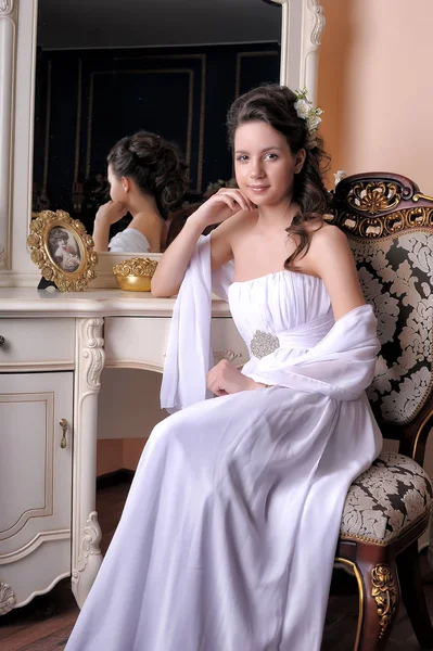 Brunette Girl White Evening Dress Sits Mirror — Stock Photo, Image