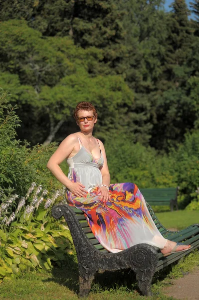 Žena Krátkým Účesem Dlouhé Letní Sarafán Sedí Lavičce Parku — Stock fotografie