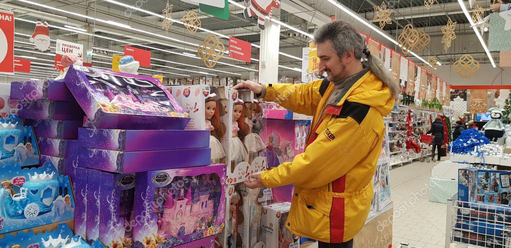 Russia, St. Petersburg, 12,12,2018 A man chooses gifts for children in the department of toys, dolls  in the supermarket