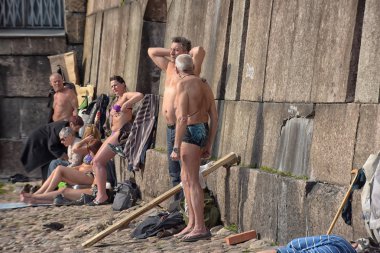 Citizens sunbathing at the walls of the Peter and Paul Fortress  clipart