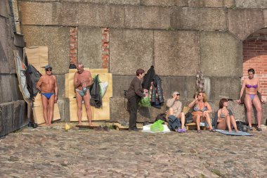Citizens sunbathing at the walls of the Peter and Paul Fortress  clipart