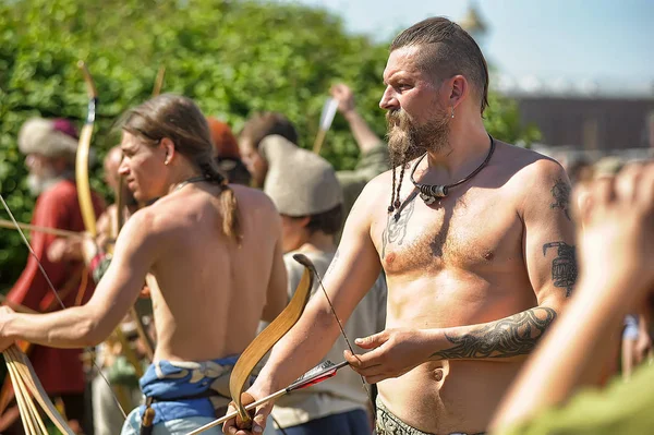 Lidé ve středověkých šatech střílet z luku na festivalu h — Stock fotografie