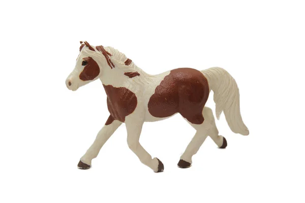 Braunes Spielzeug mit weißem Pferd auf weißem Hintergrund — Stockfoto