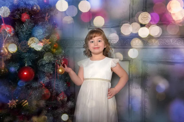 Ragazza in abito sta vicino all'albero di Natale — Foto Stock