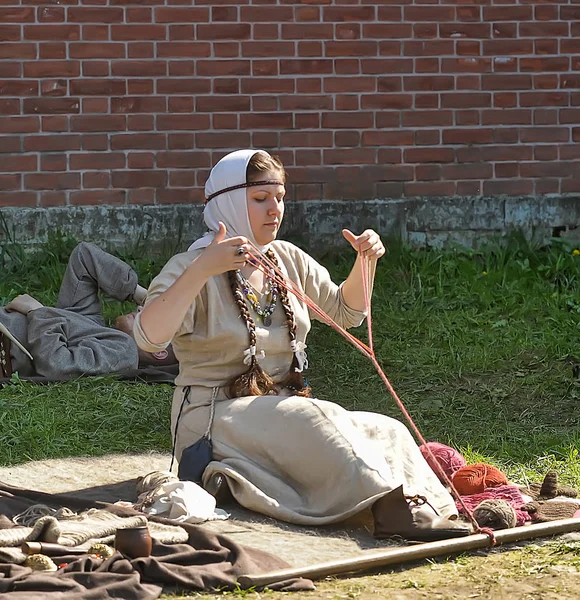 Une femme en costume médiéval est engagée dans la couture pour le h — Photo