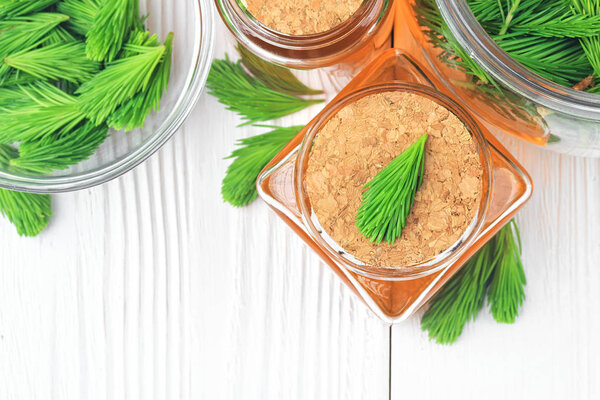 Homemade pine cough syrup for dry irritating throat coughs. Made from green young pine buds and honey.Alternative medicine concept on white wooden table,top view (selective focus).