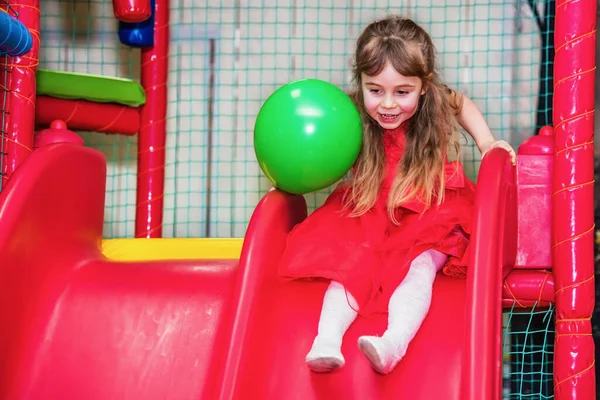 Girl Playing Children Room She Rides Small Slide — Stock Photo, Image