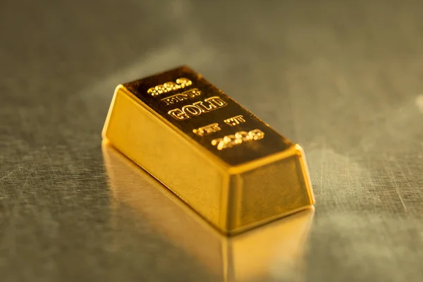 bar of gold on metal background