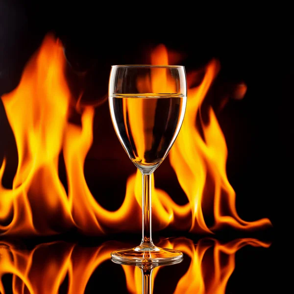 Wine glass on black with flames Royalty Free Stock Photos