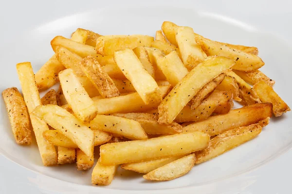 Patatine fritte su un piatto bianco Immagine Stock