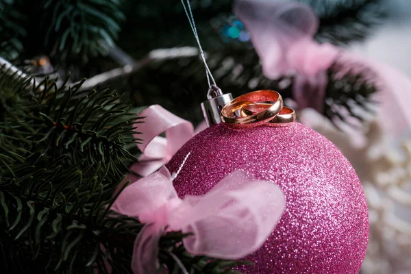 结婚戒指 粉红色的圣诞球 雪中的圣诞树 — 图库照片