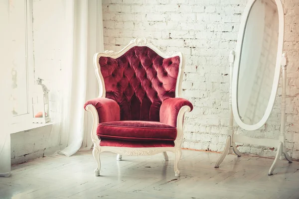 Armchair near window . Red armchair iin an empty  wall in living room interior.