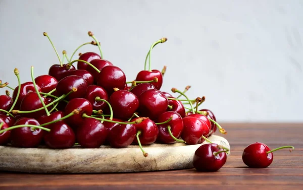 Delicious red cherries on a wooden background