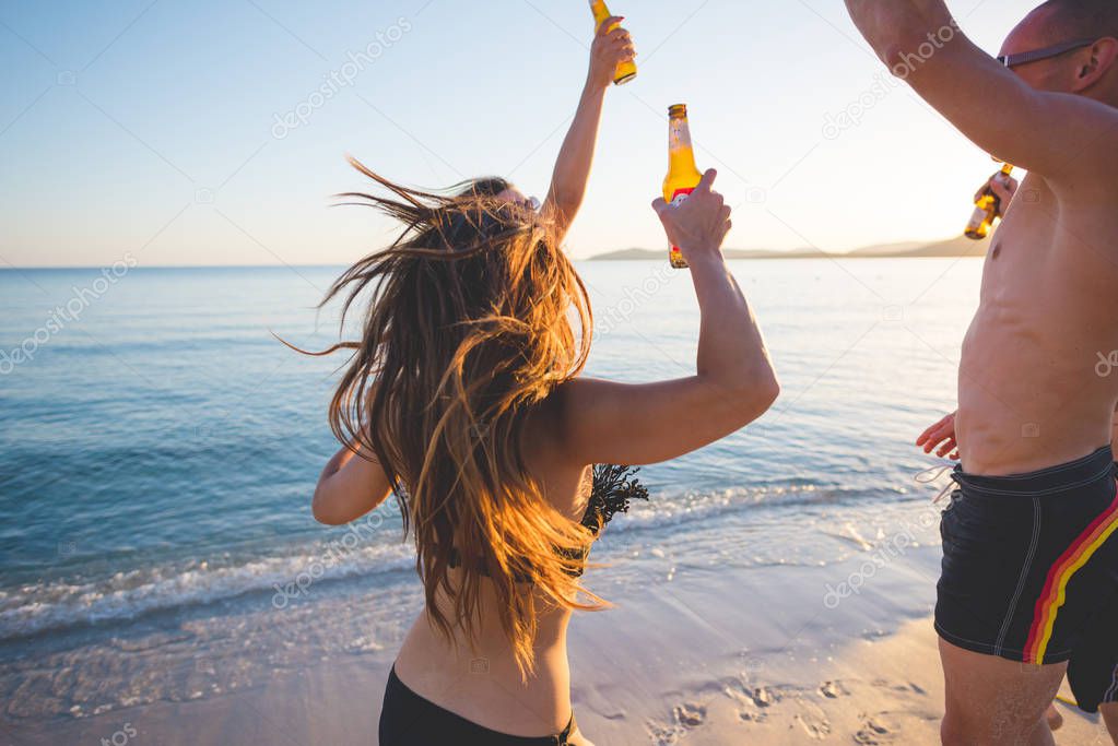 Group of friends millennials having fun on the beach 
