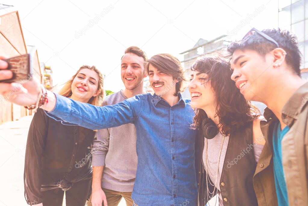 group of friends millennials using smartphone taking selfie