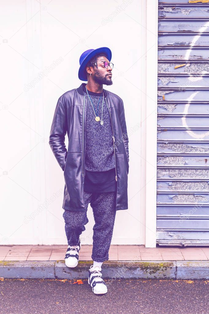 young bearded african man outdoors posing looking away - swag, street style, hip-hop concept