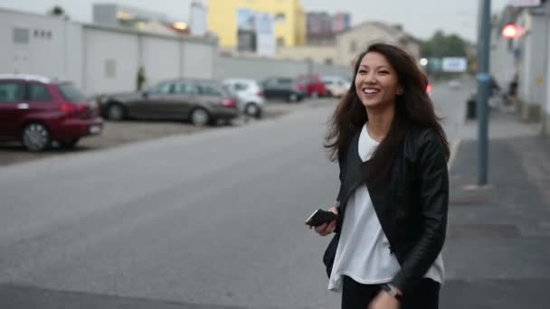 スマートフォンを持ち 路上でヒッチハイクをする若い美しいアジアの女性 — ストック動画