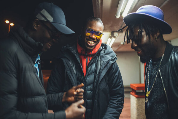 three african men standing in the street and having conversation
