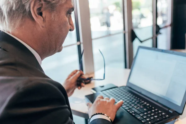 Middle Age Contemporary Businessman Indoor City Sitting Bar Using Laptop Royalty Free Stock Photos