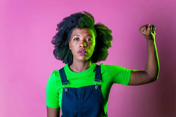 Confident black woman protesting against racial discrimination isolated on pink background - Young diverse african woman showing black lives matter gesture - stop racism, demonstration, human rights concept