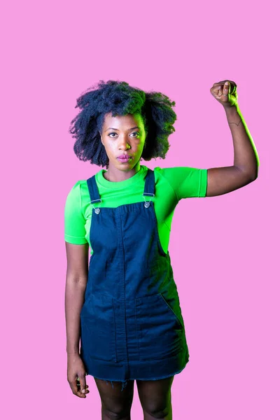 Confident black woman protesting against racial discrimination isolated on pink background - Young diverse african woman showing black lives matter gesture - stop racism, demonstration, human rights concept