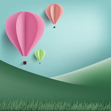Sıcak hava balonu kağıt sanat tarzı ve yeşil çimen dağ arka planı.