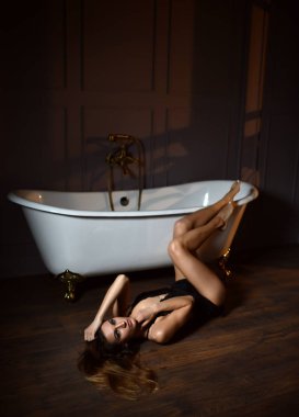 Genç güzel kadın banyoda pahalı küvet banyo yakınındaki yalan 