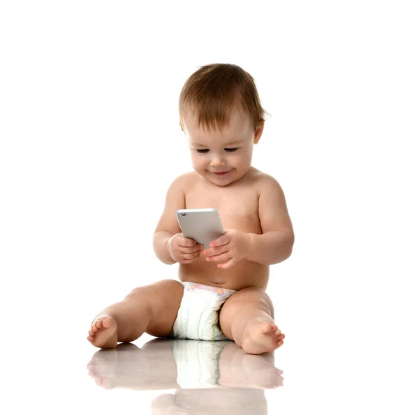 Infant child baby girl toddler playing with mobile cellphone happy smiling — Stock Photo, Image