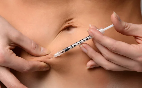 Medical diabetes insulin syringe injection shot into abdomen with text copy space — Stock Photo, Image