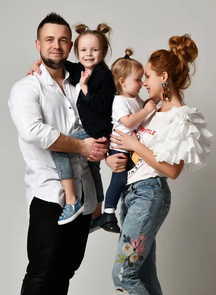 Happy family mother father and two daughter girls  smiling on gray studio — Stock Photo, Image