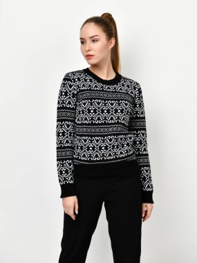 Genç güzel kadın yeni rahat gri kazak üzerine beyaz bir poz 