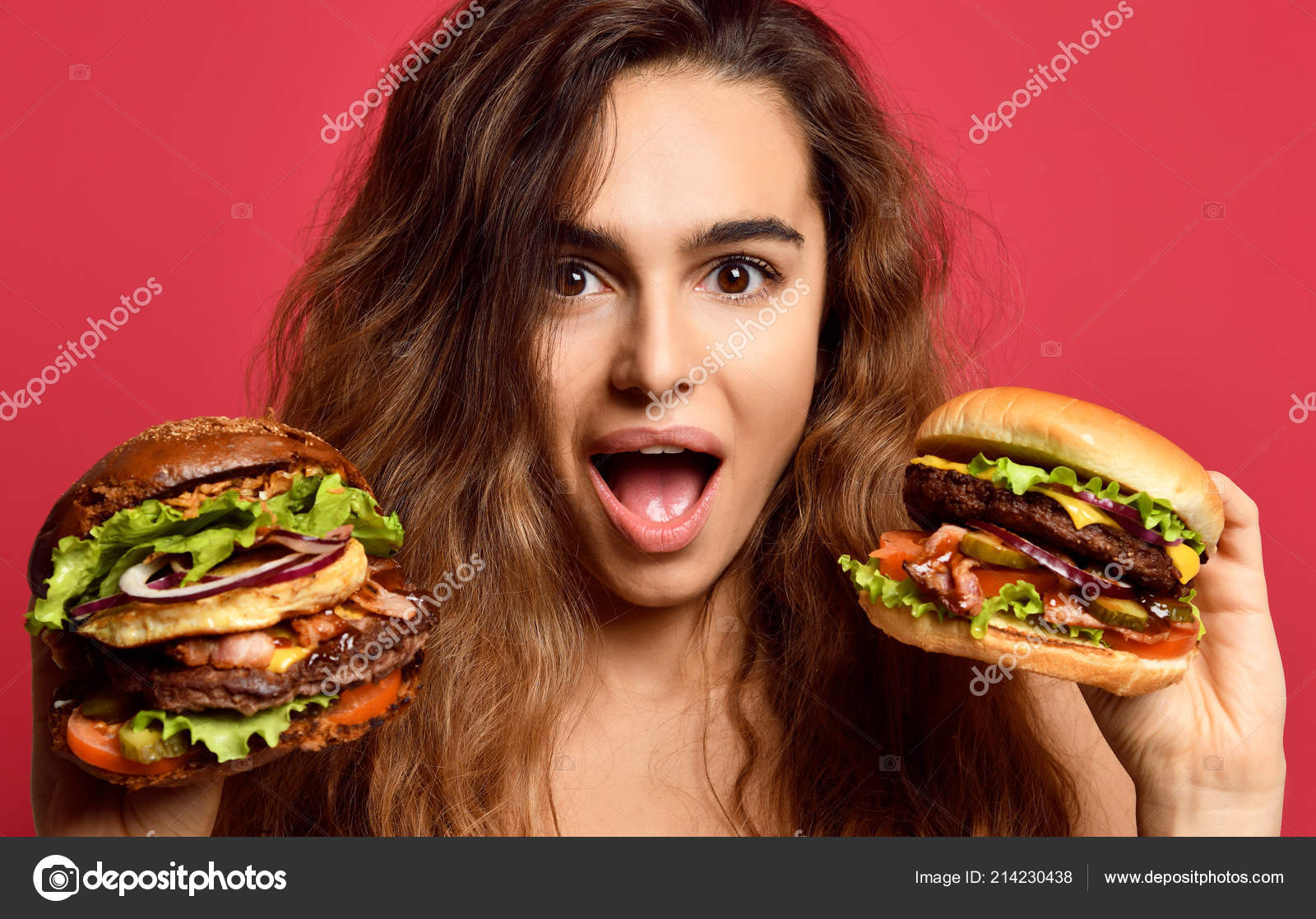 Woman compare big beef burger sandwich and huge cheeseburger with