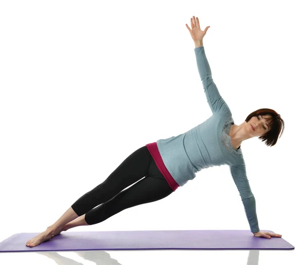 Female fitness instructor doing stretching for hands legs abdominals bar exercise in gym work out isolated on white — Stock Photo, Image