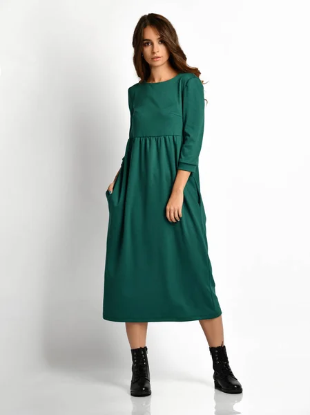 若い美しい女性が高い丘全身に新しい暗い緑ファッション冬のドレスでポーズ — ストック写真