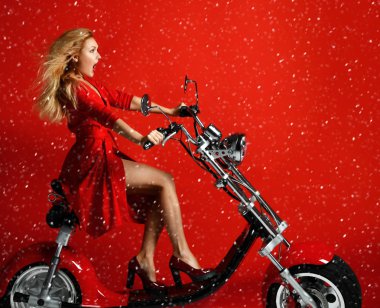 Woman ride new electric car motorcycle bicycle scooter present for new year 2019 in red dress on red background surprised clipart