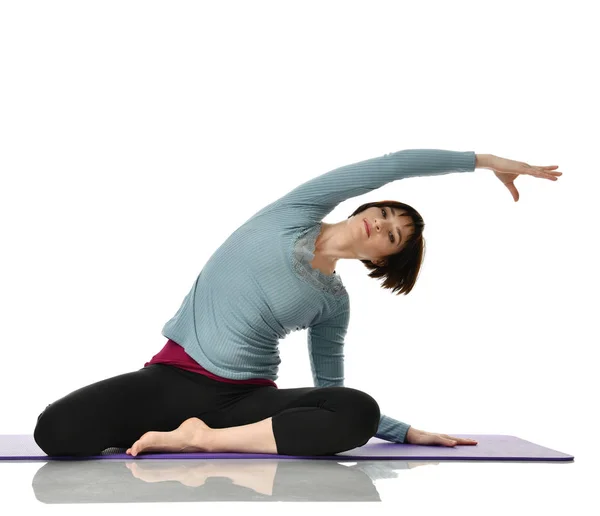 Female fitness instructor doing stretching for hands legs abdominals bar exercise in gym work out isolated on white — Stock Photo, Image