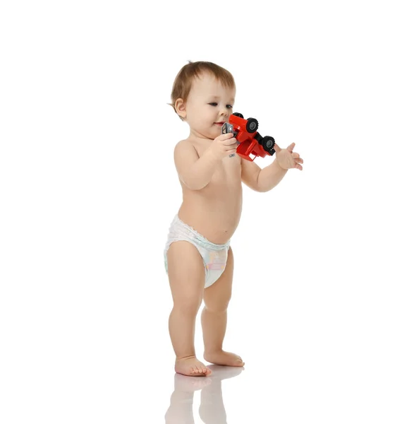 Infant child baby girl toddler playing with little red car happy smiling isolated a white — Stock Photo, Image